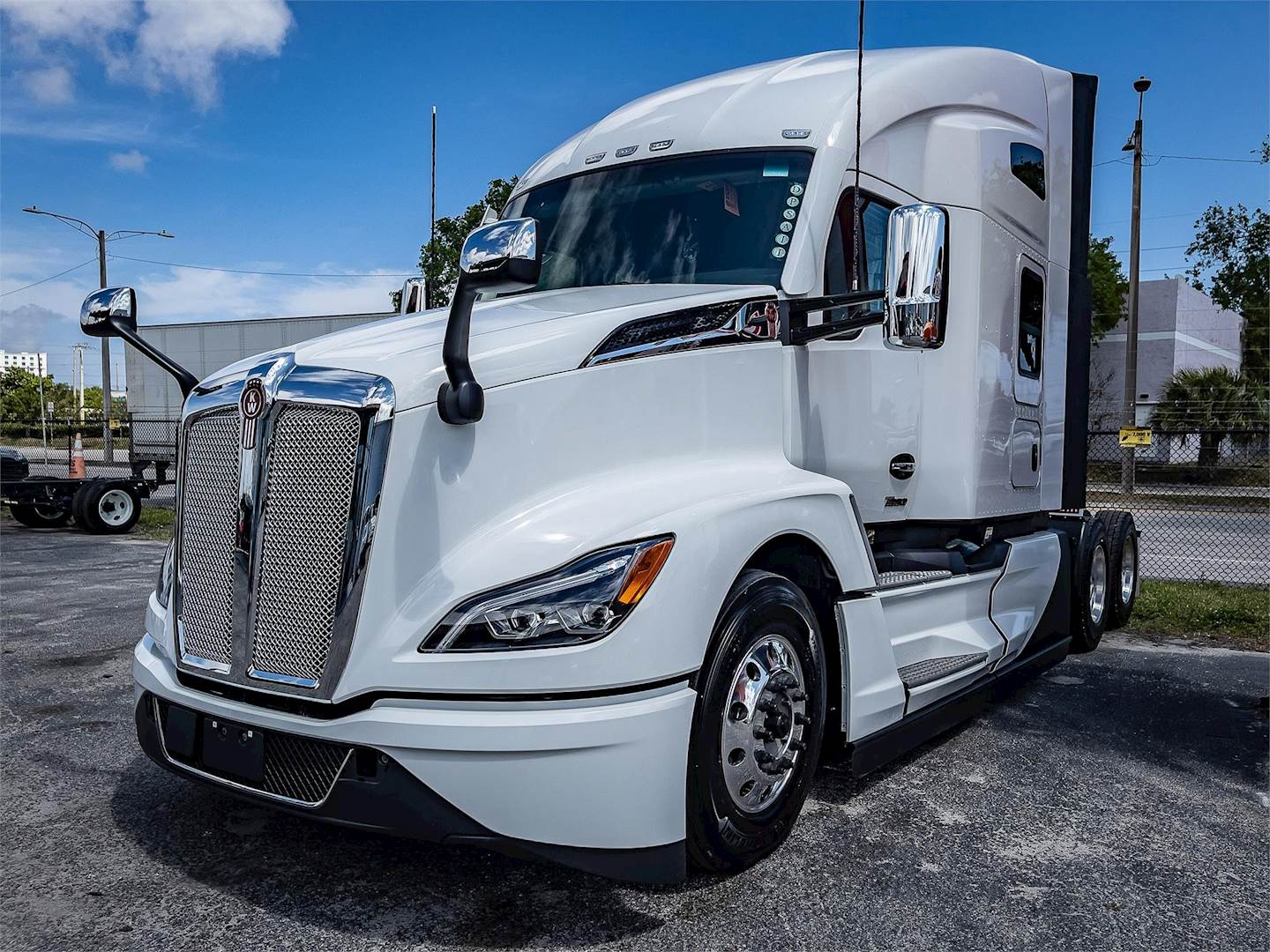 A white truck parked on the side of the road.