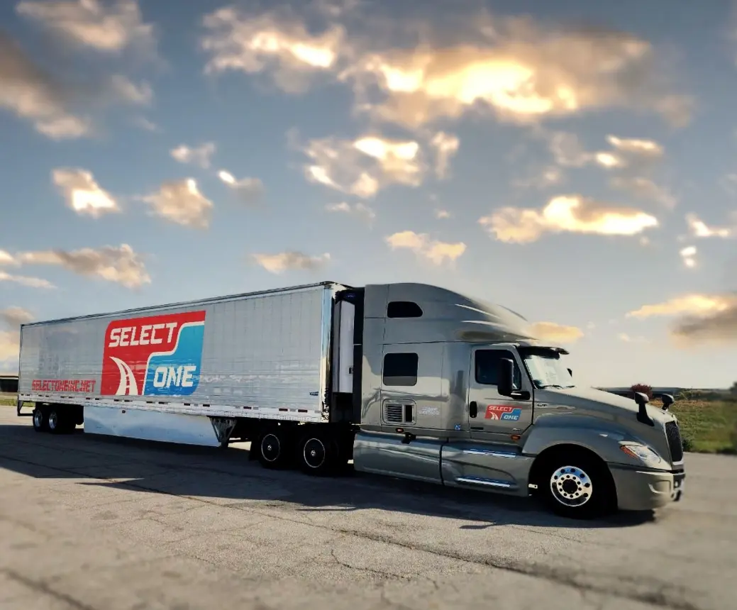 A semi truck is parked on the side of the road.